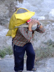 Nepalses man carrying a sack of sand
